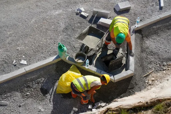 North Georgia concrete installation service with workers setting new curbs and pavement edges