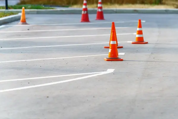 North Georgia parking lot repair and maintenance project with safety cones in place for work zone protection.